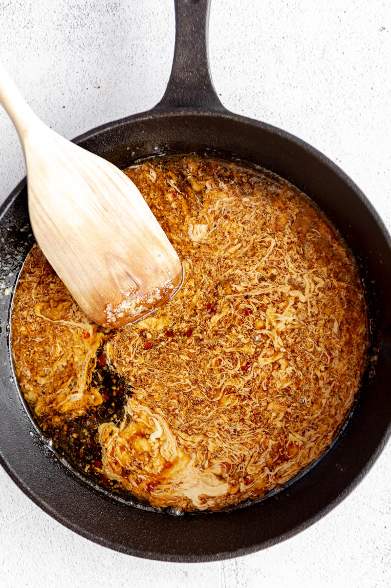 Ingredients for tahini sauce being cooked in pan.