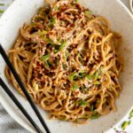 Sesame Tahini Noodles recipe in a bowl with chopsticks.