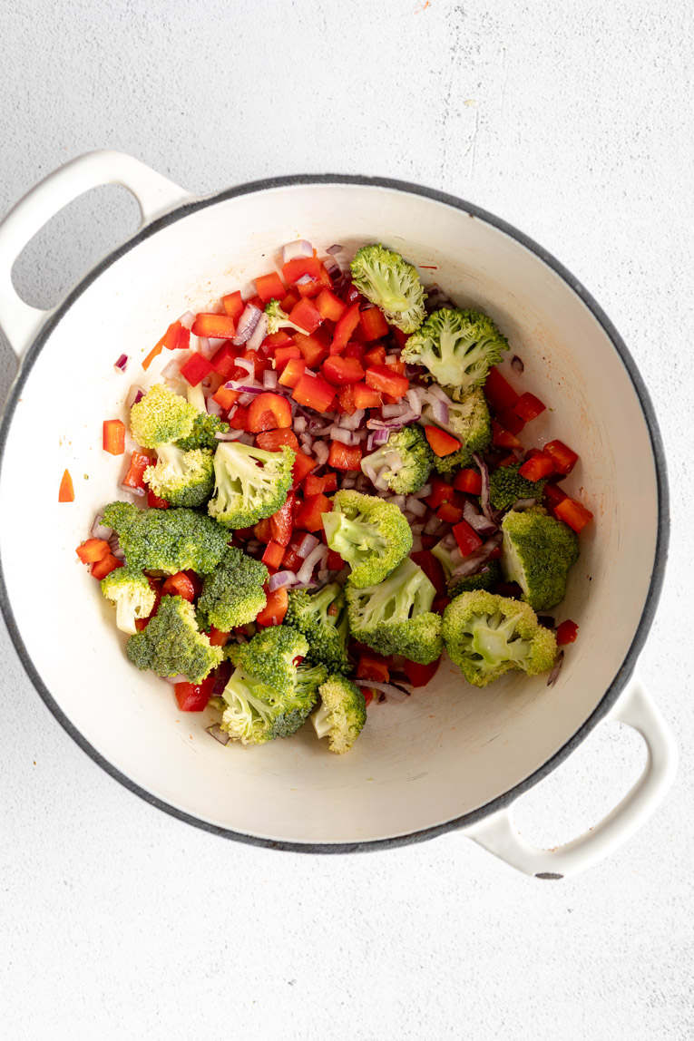 Broccoli and bell pepper being sautéed.
