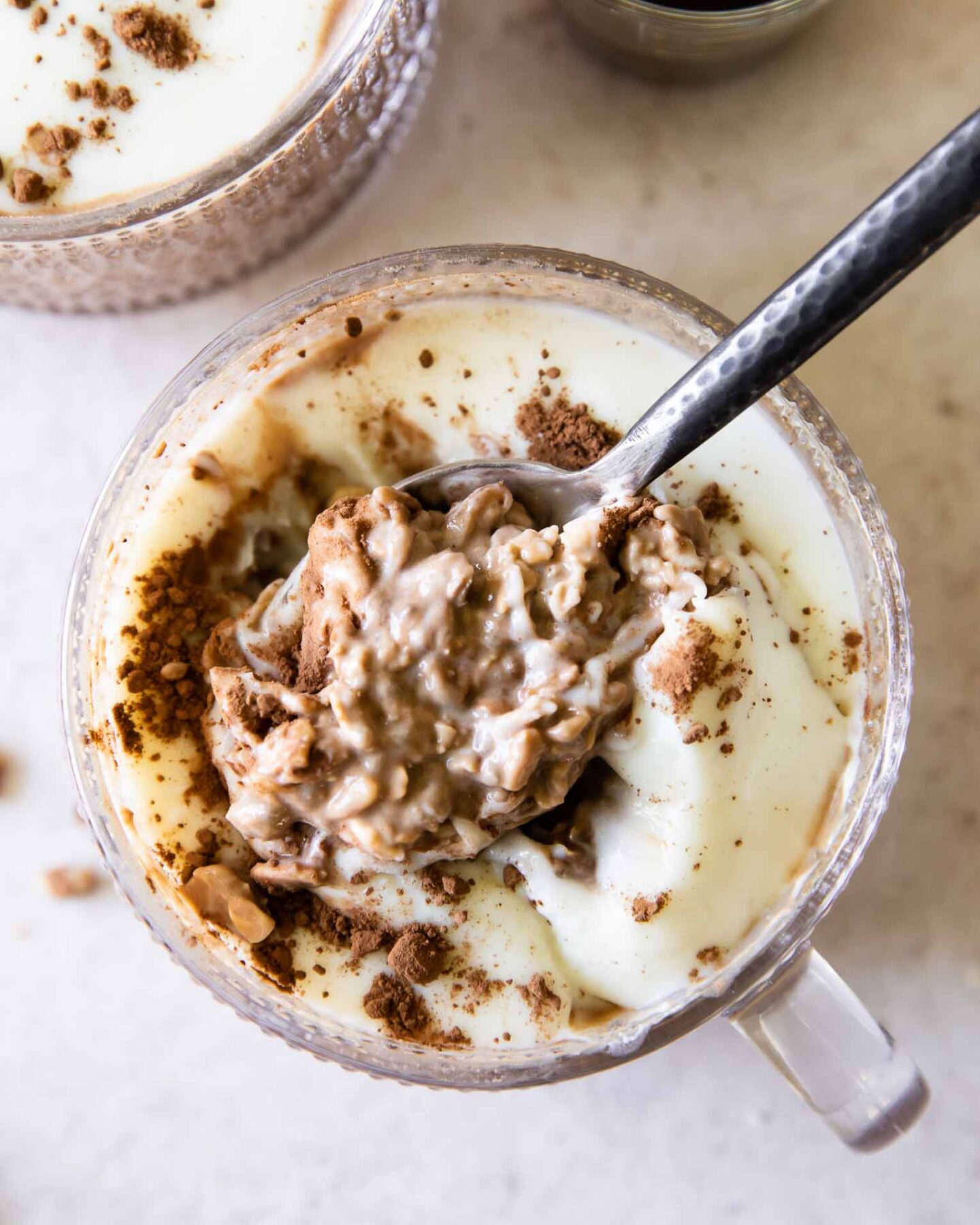 Spoonful of Tiramisu Overnight Oats with creamy yogurt topping.