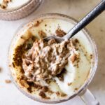 Spoonful of Tiramisu Overnight Oats with creamy yogurt topping.