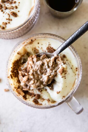 Spoonful of Tiramisu Overnight Oats with creamy yogurt topping.