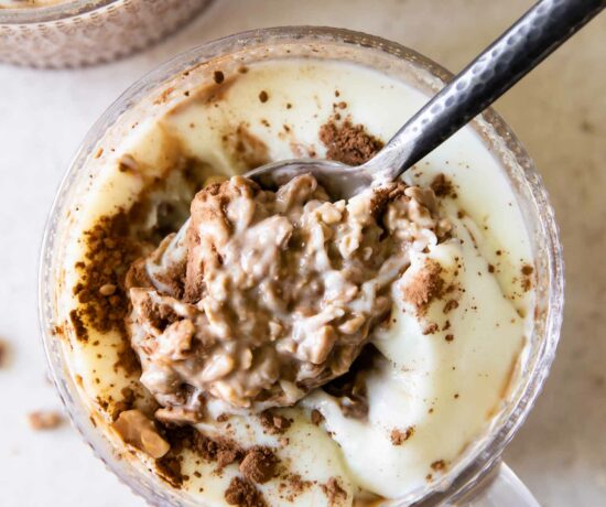 Spoonful of Tiramisu Overnight Oats with creamy yogurt topping.
