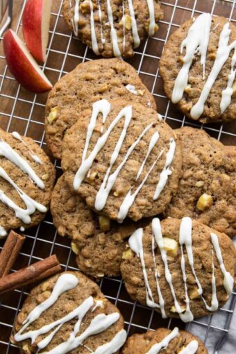 Apple Pie Cookies with white chocolate drizzle on a cookie rack.