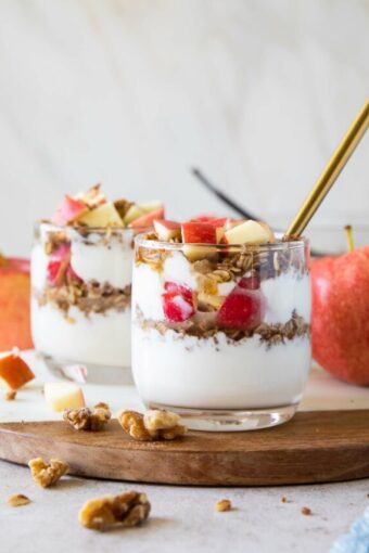 Healthy Apple Crumble Parfaits on a cutting board.