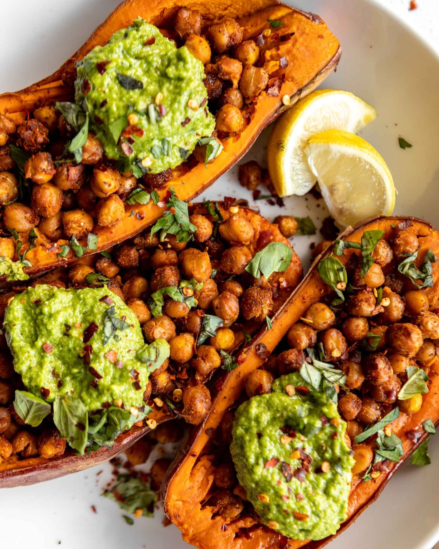 Baked Sweet Potatoes w/ Chickpeas & Broccoli Pesto on a plate.