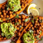 Baked Sweet Potatoes w/ Chickpeas & Broccoli Pesto on a plate.