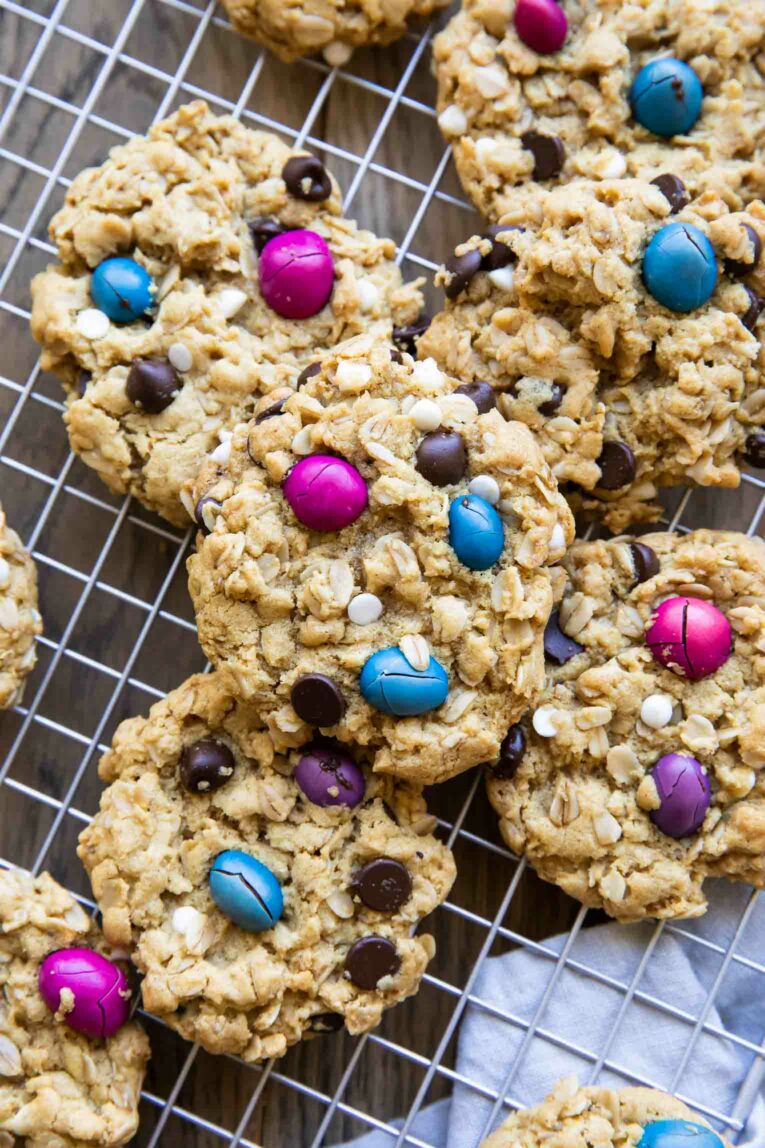 Gluten-Free Monster Cookies on a cooling rack with coated chocolate candy.