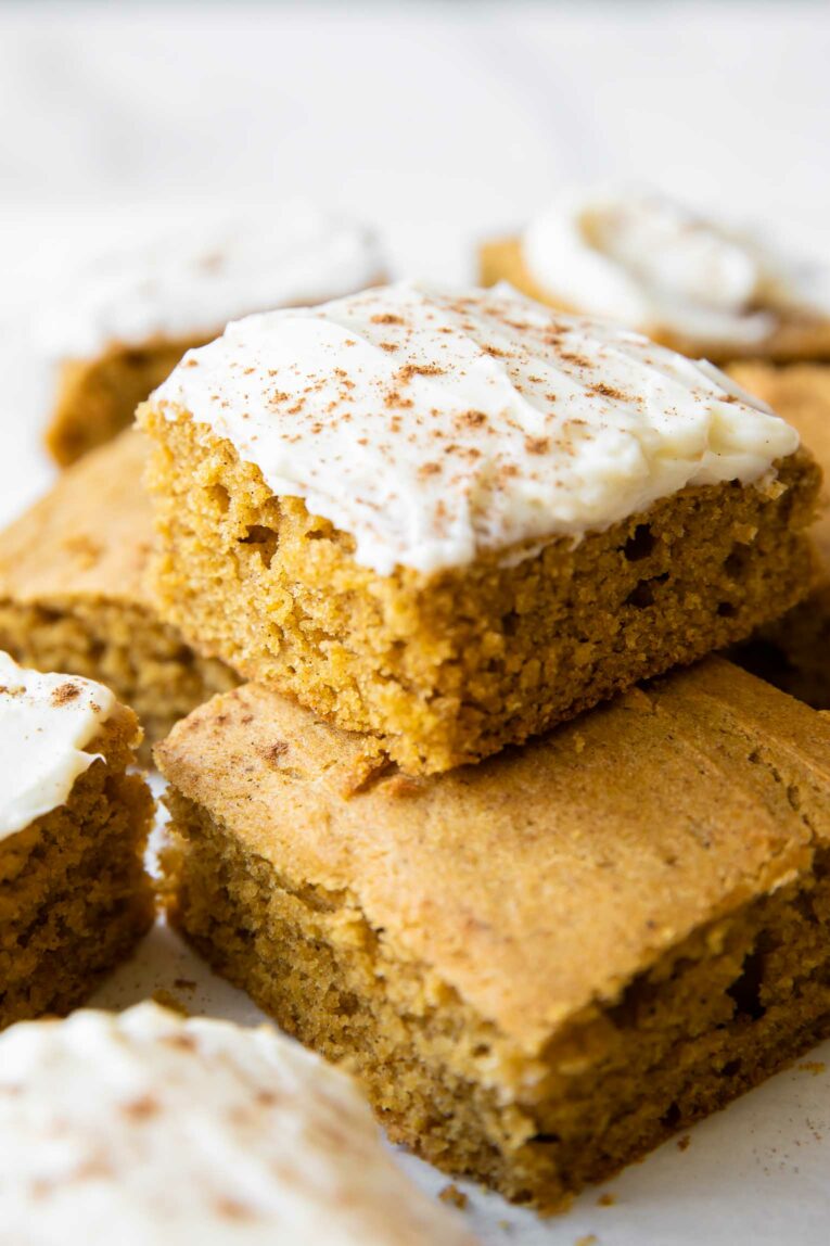 Stacked Gluten-Free Pumpkin Bars with cream cheese icing.