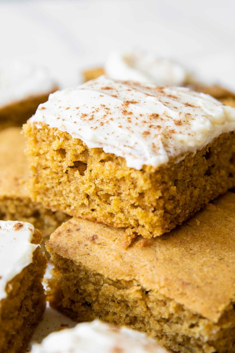 Close up of Gluten-Free Pumpkin Bars with cream cheese frosting.