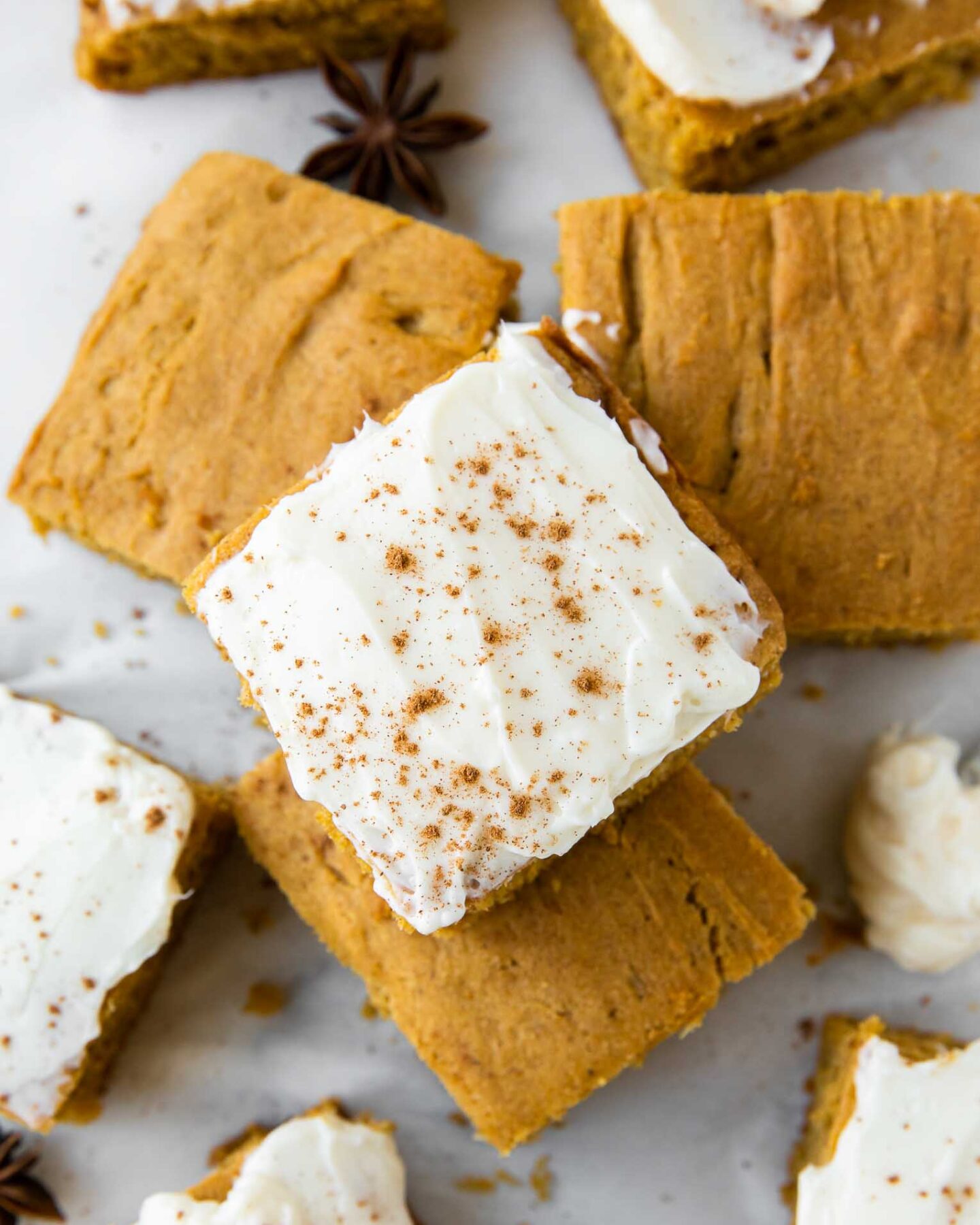 Top shot photo of Gluten-Free Pumpkin Bars with icing and pumpkin spice.