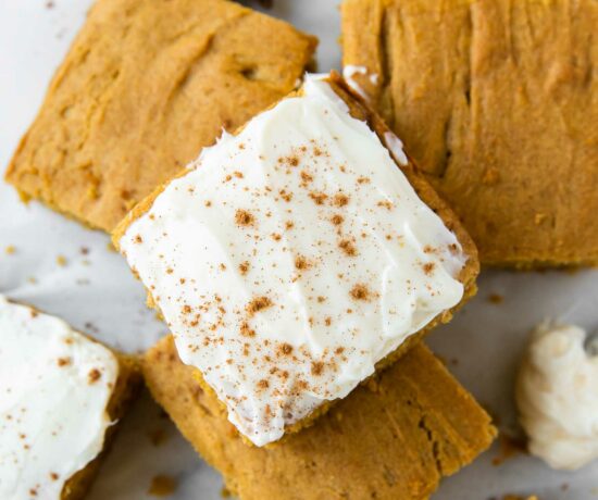 Top shot photo of Gluten-Free Pumpkin Bars with icing and pumpkin spice.