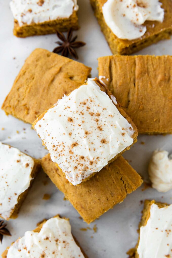 Top shot photo of Gluten-Free Pumpkin Bars with icing and pumpkin spice.