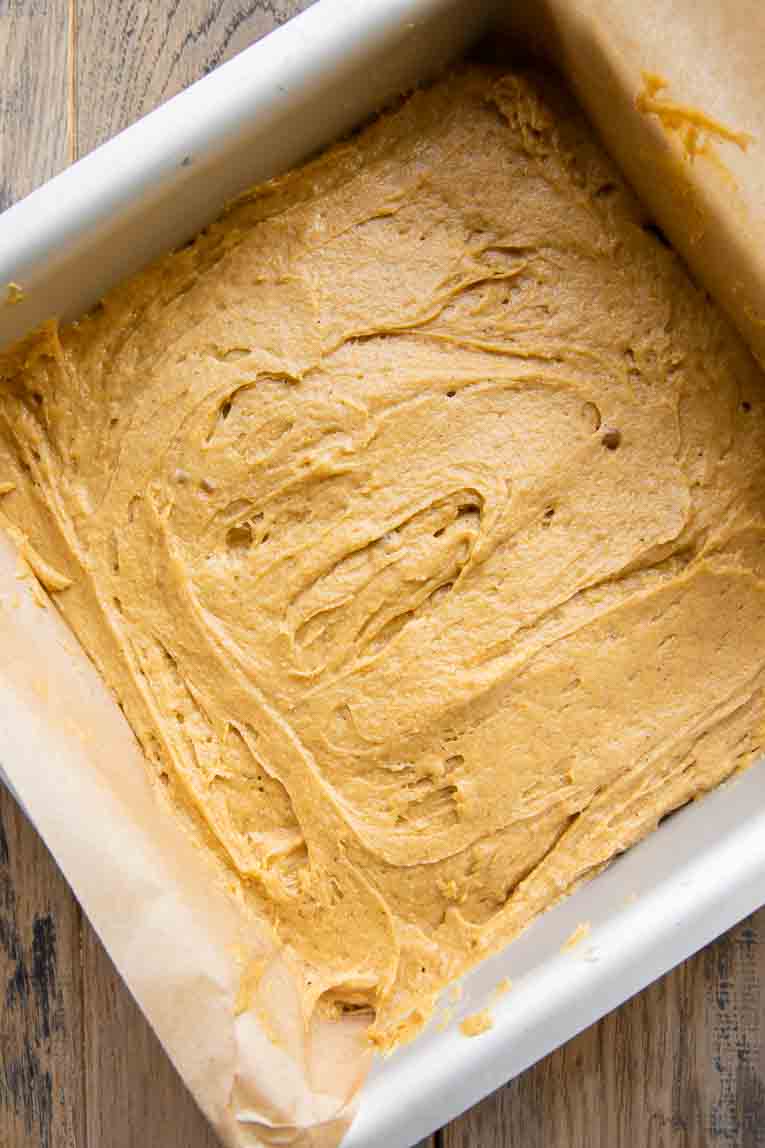 Pumpkin cake bars batter in a square pan.