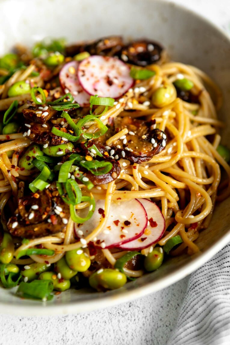 Close up of Miso mushroom noodles bowl with sliced radish.