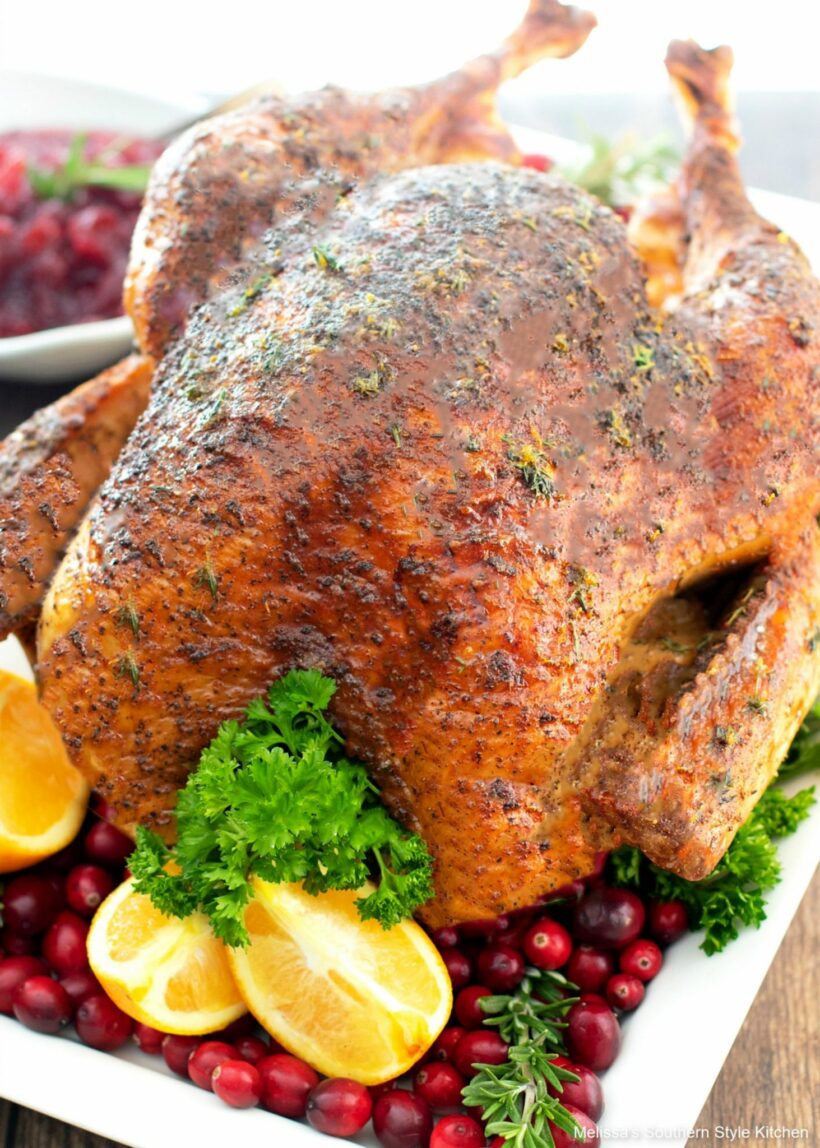 Over roasted turkey with parsley, lemon, and cranberries.