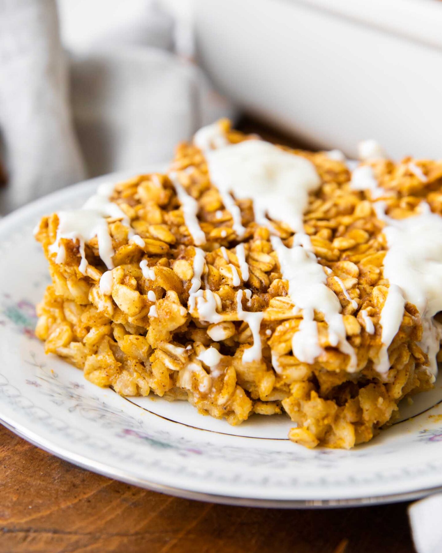 Close up of Pumpkin Baked Oatmeal with white chocolate drizzle.