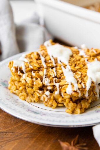 Close up of Pumpkin Baked Oatmeal with white chocolate drizzle.