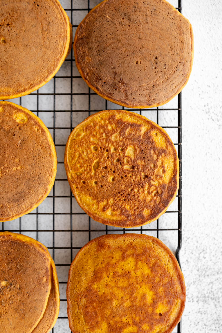 Pumpkin Oatmeal Pancakes cooling on a cooling rack.