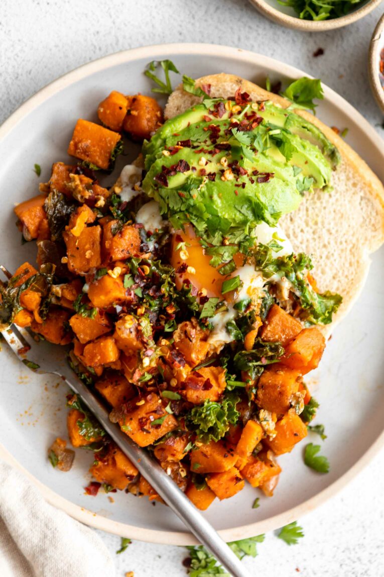 Plated Sweet Potato Kale Hash browns with avocado.