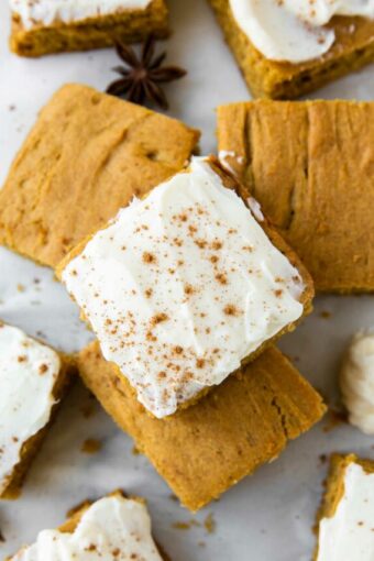 Top shot photo of Gluten-Free Pumpkin Bars with icing and pumpkin spice.