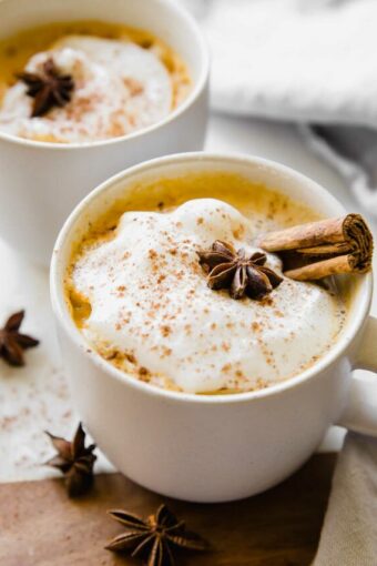 Angled photo of Pumpkin Chai Latte in a mug with whipped cream.