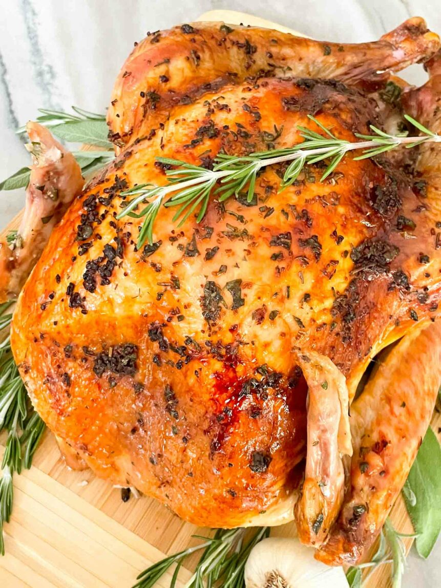 Herb butter roasted turkey with rosemary on top.