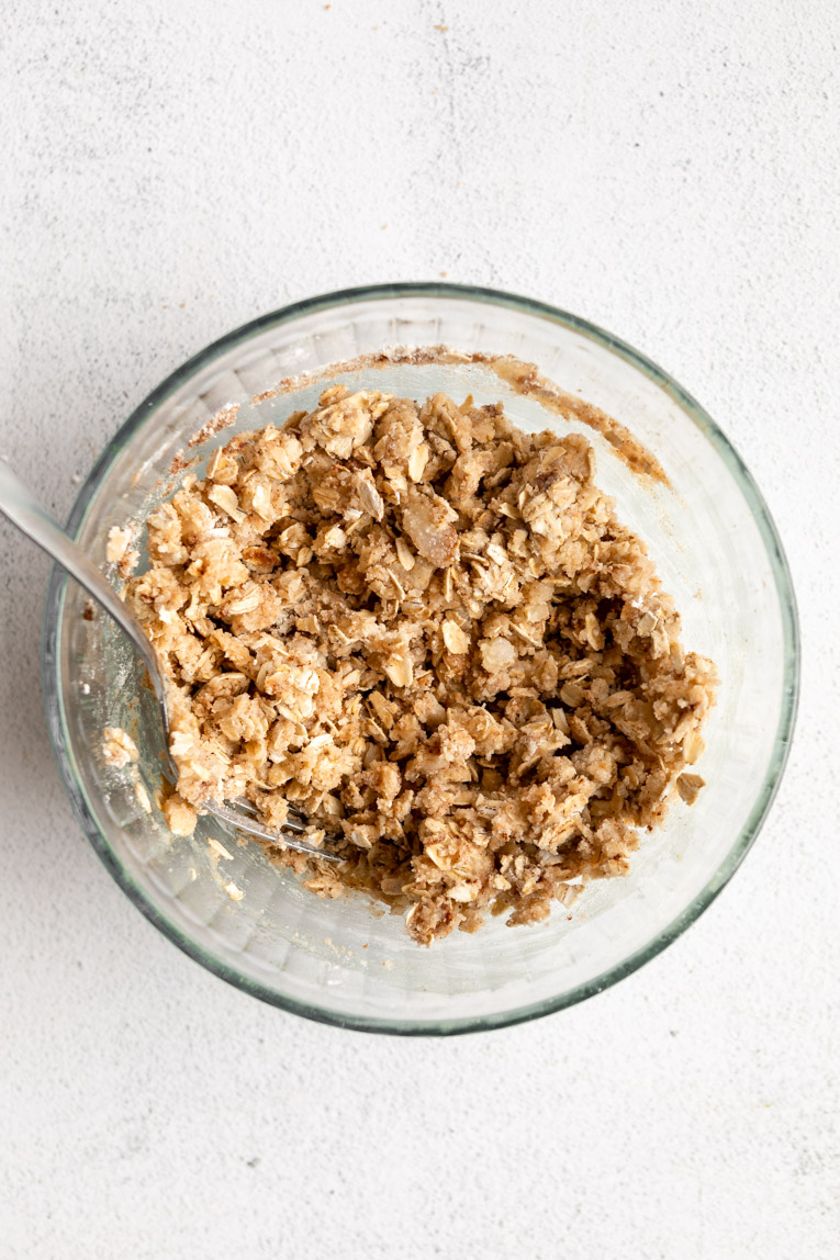 Oat crumble topping mixed together in a bowl.