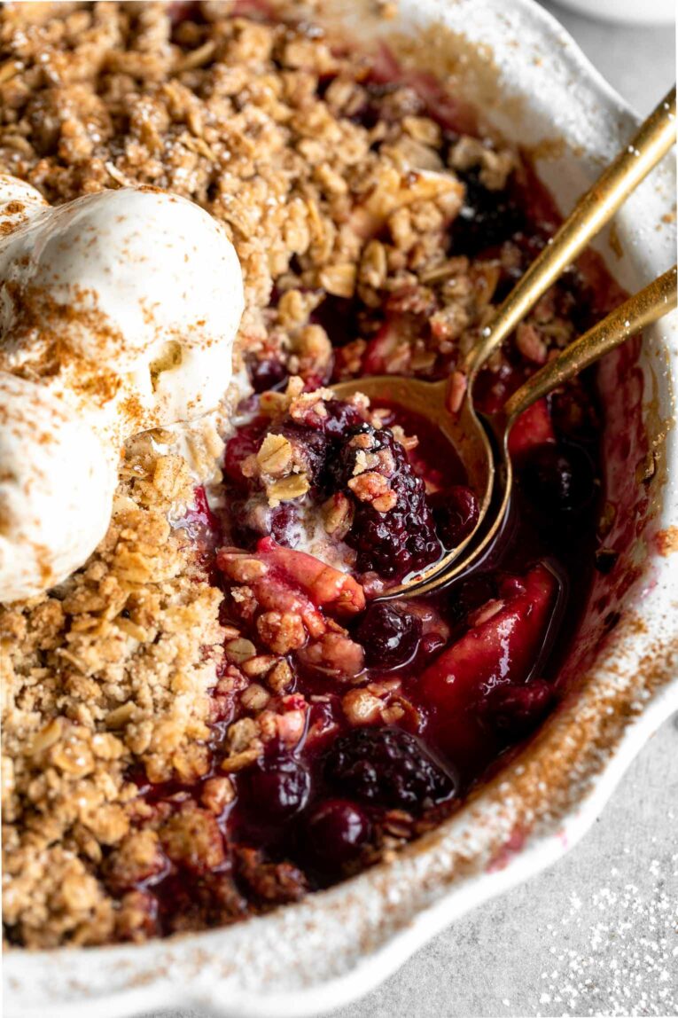 Angled photo of Apple Blackberry Crumble Fruit Bake in a pie pan.