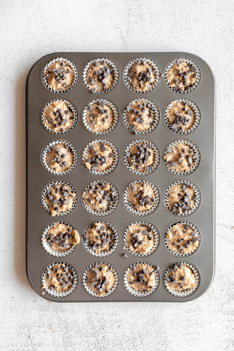 Baked oatmeal cups with bananas and chocolate chips in a mini muffin tin.