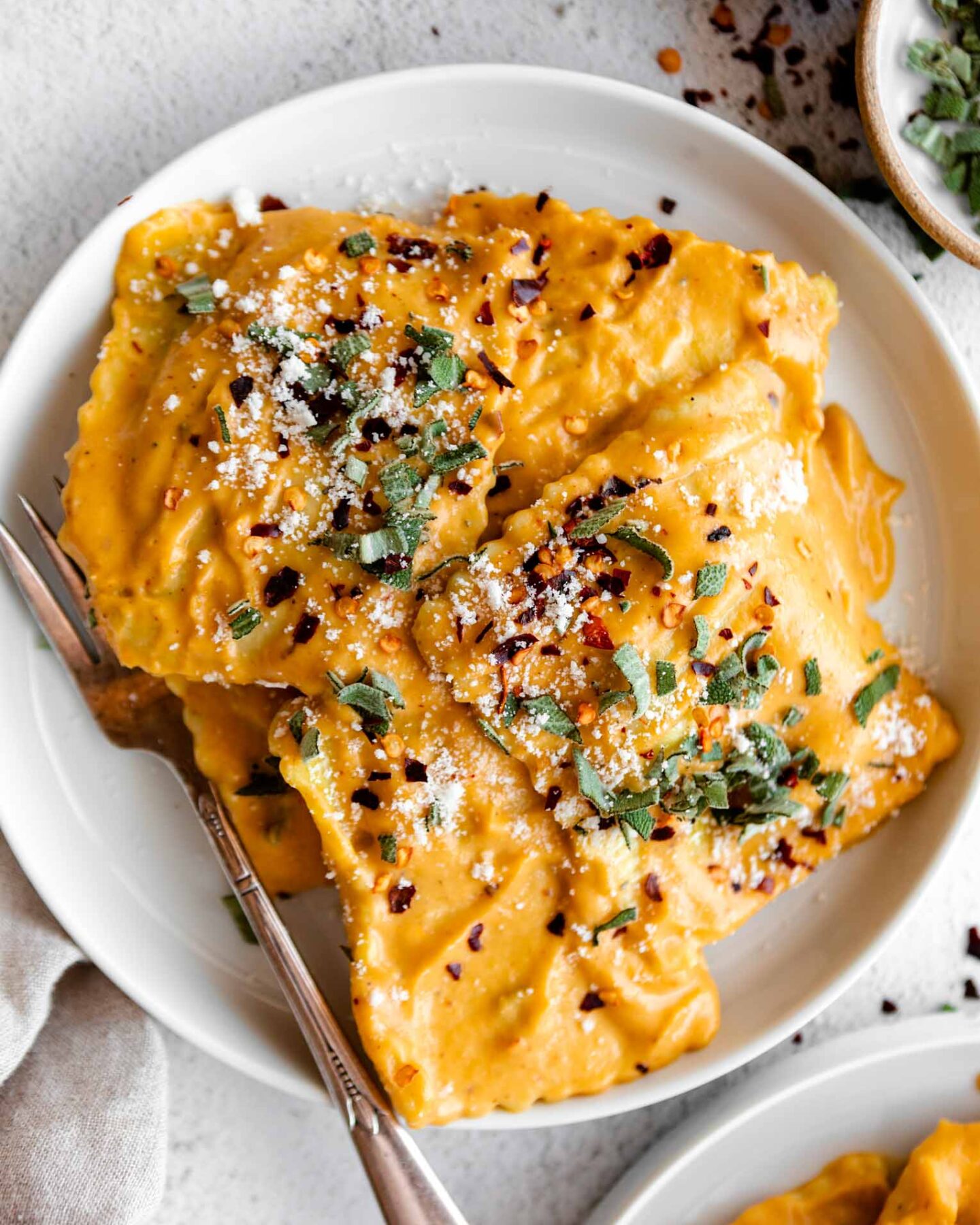 Top close up photo of Butternut Squash Ravioli in a butternut squash sauce.