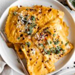Top close up photo of Butternut Squash Ravioli in a butternut squash sauce.