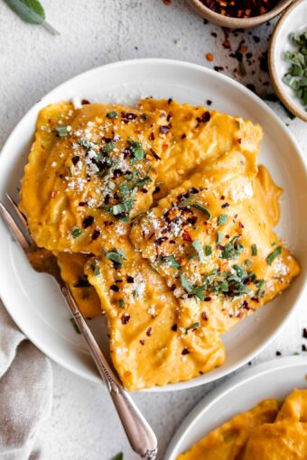 Top close up photo of Butternut Squash Ravioli in a butternut squash sauce.