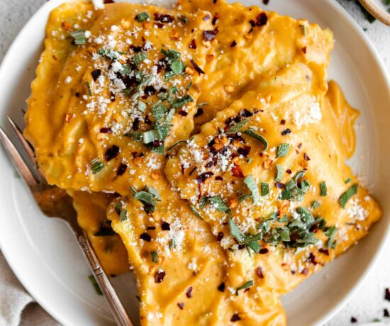 Top close up photo of Butternut Squash Ravioli in a butternut squash sauce.