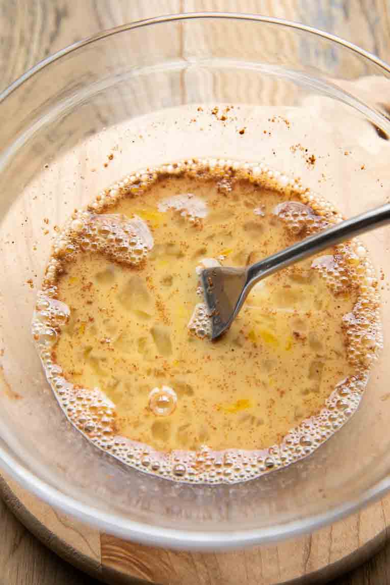 Egg mixture for french toast bagels in a mixing bowl.