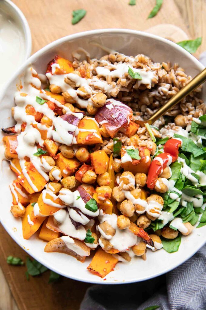 Harissa Veggie Bowls recipe with a fork and tahini drizzle!