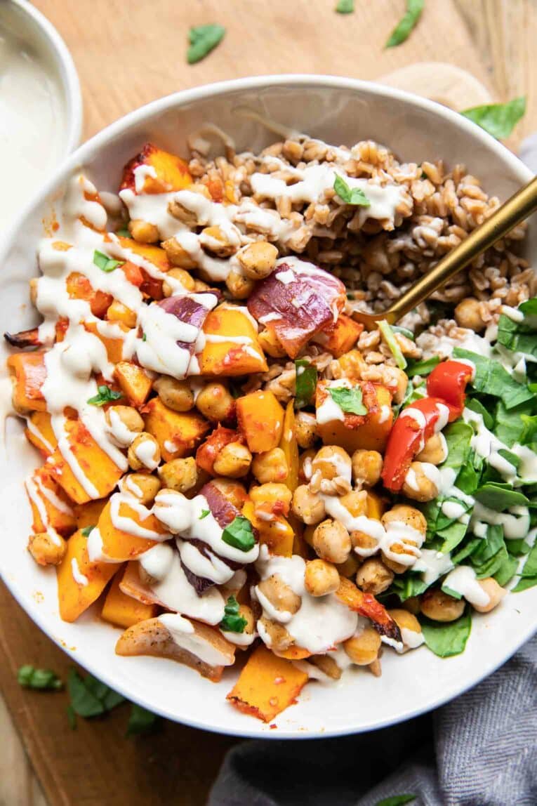 Harissa Veggie Bowls recipe with a fork and tahini drizzle!