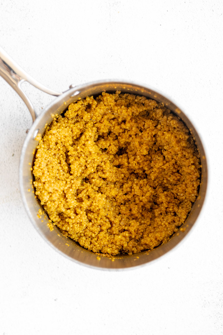 Curry quinoa being cooked in a pot.