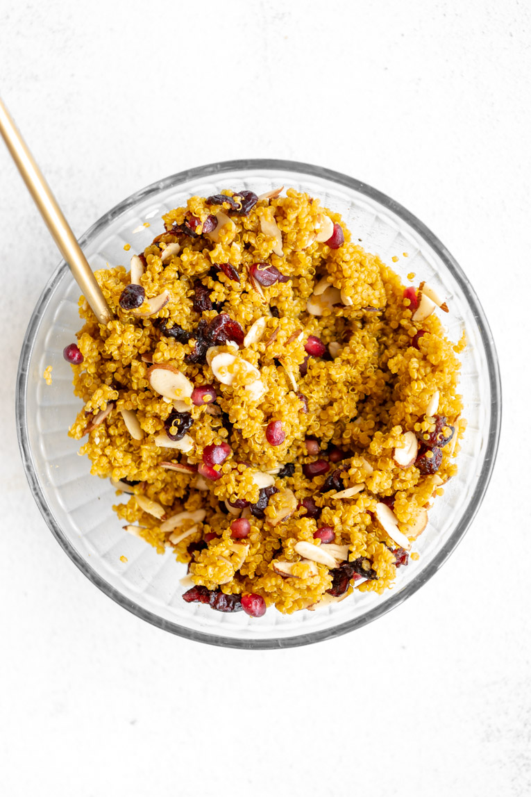 Curry quinoa combined with pomegranate seeds, dried cranberries, and almonds.