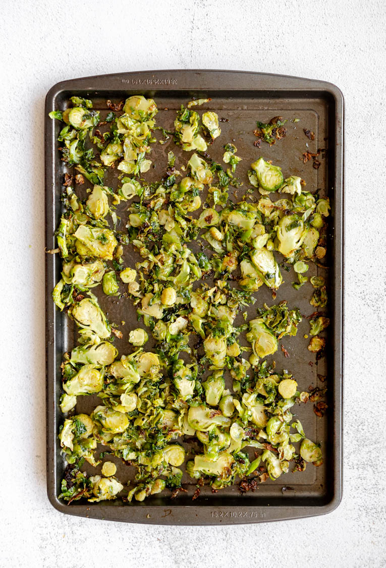 Roasted shredded Brussels sprouts on a baking sheet.