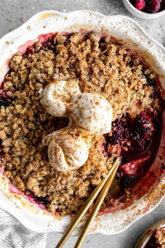 Top shot photo of Apple Blackberry Crumble Fruit Bake with cranberries and vegan ice cream on top.