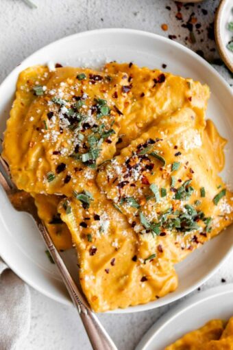 Top close up photo of Butternut Squash Ravioli in a butternut squash sauce.