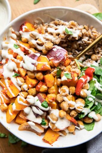 Harissa Veggie Bowls recipe with a fork and tahini drizzle!