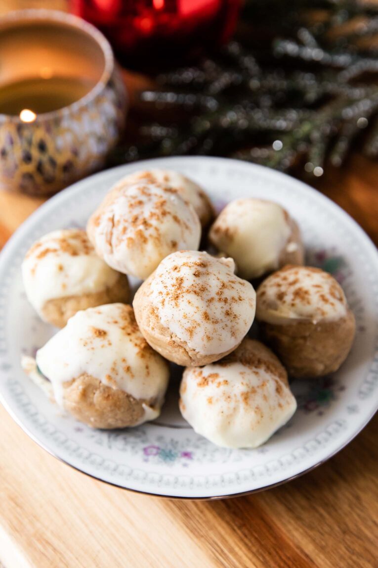 Gingerbread Cookie Protein Bites recipe on a plate with white chocolate topping.