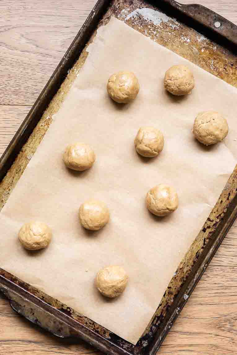 Protein bites rolled into balls and on a baking sheet.