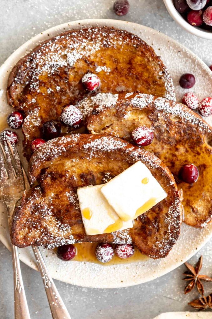 Close up of Gingerbread French Toast with powdered sugar and cranberries.