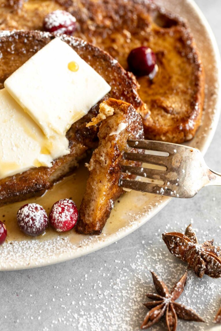 Bite being take out of slice of Gingerbread French Toast.