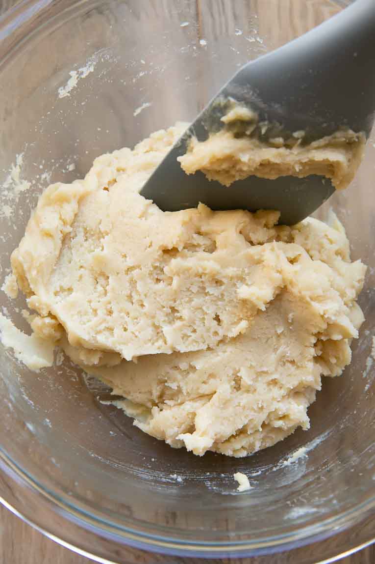 Gluten-free sugar cookie dough being mixed in a bowl.