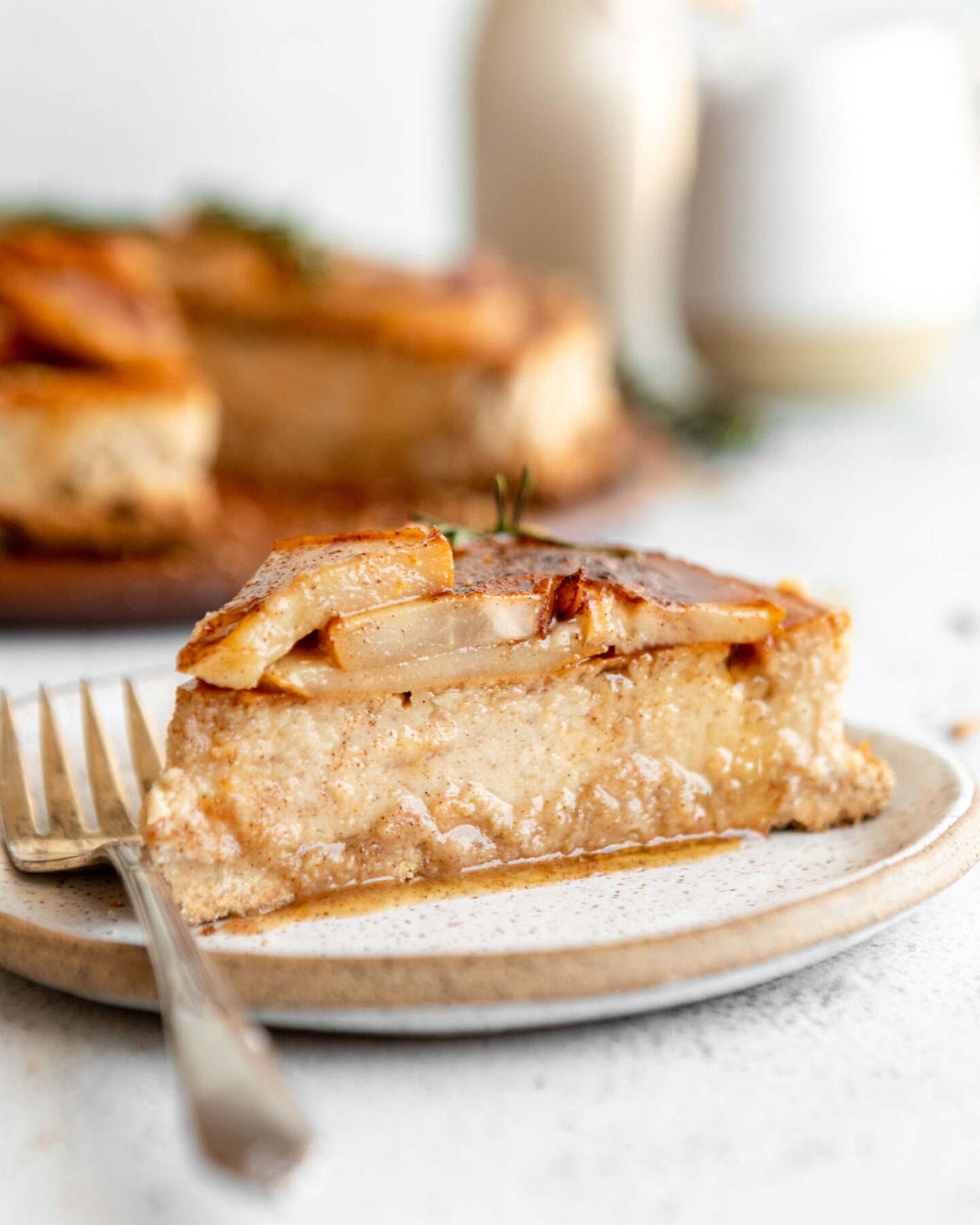 Across photo of slice of Honey Pear Ginger Cheesecake on a plate.