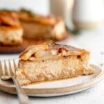 Across photo of slice of Honey Pear Ginger Cheesecake on a plate.